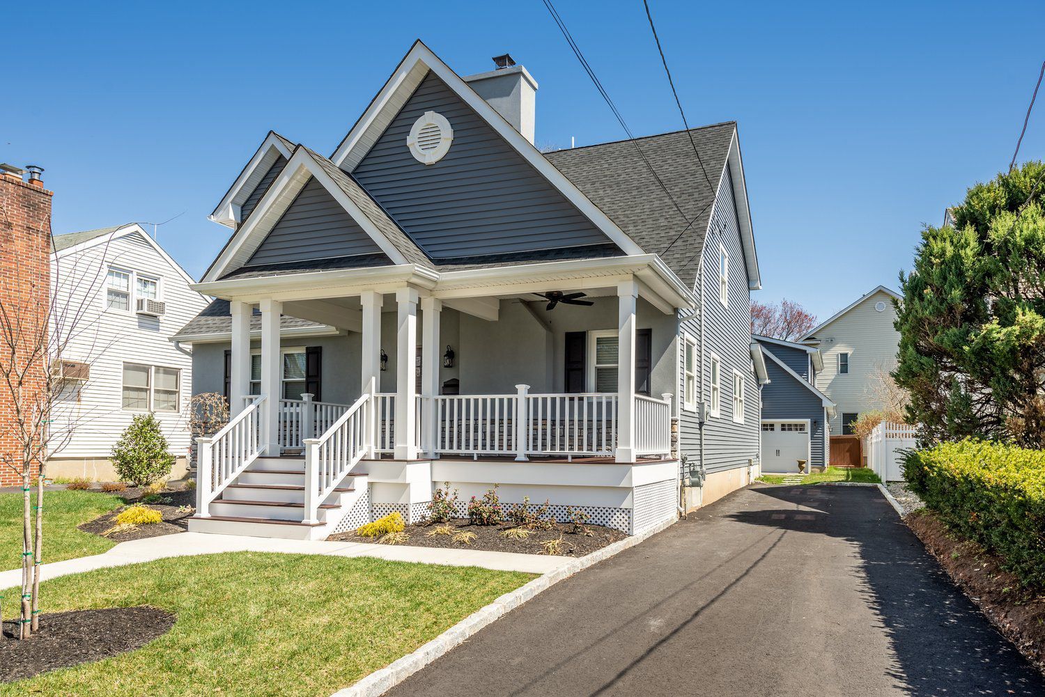 A house with a large porch and stairs is for sale.