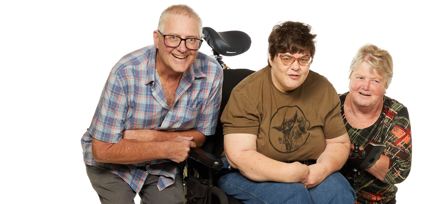 a man in a plaid shirt sits next to a woman in a wheelchair