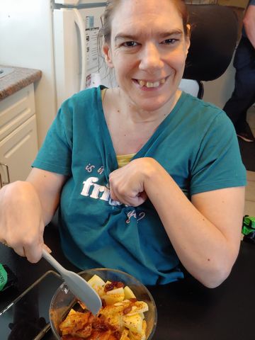 a woman wearing a shirt that says ' is it friday ' on it, cooking