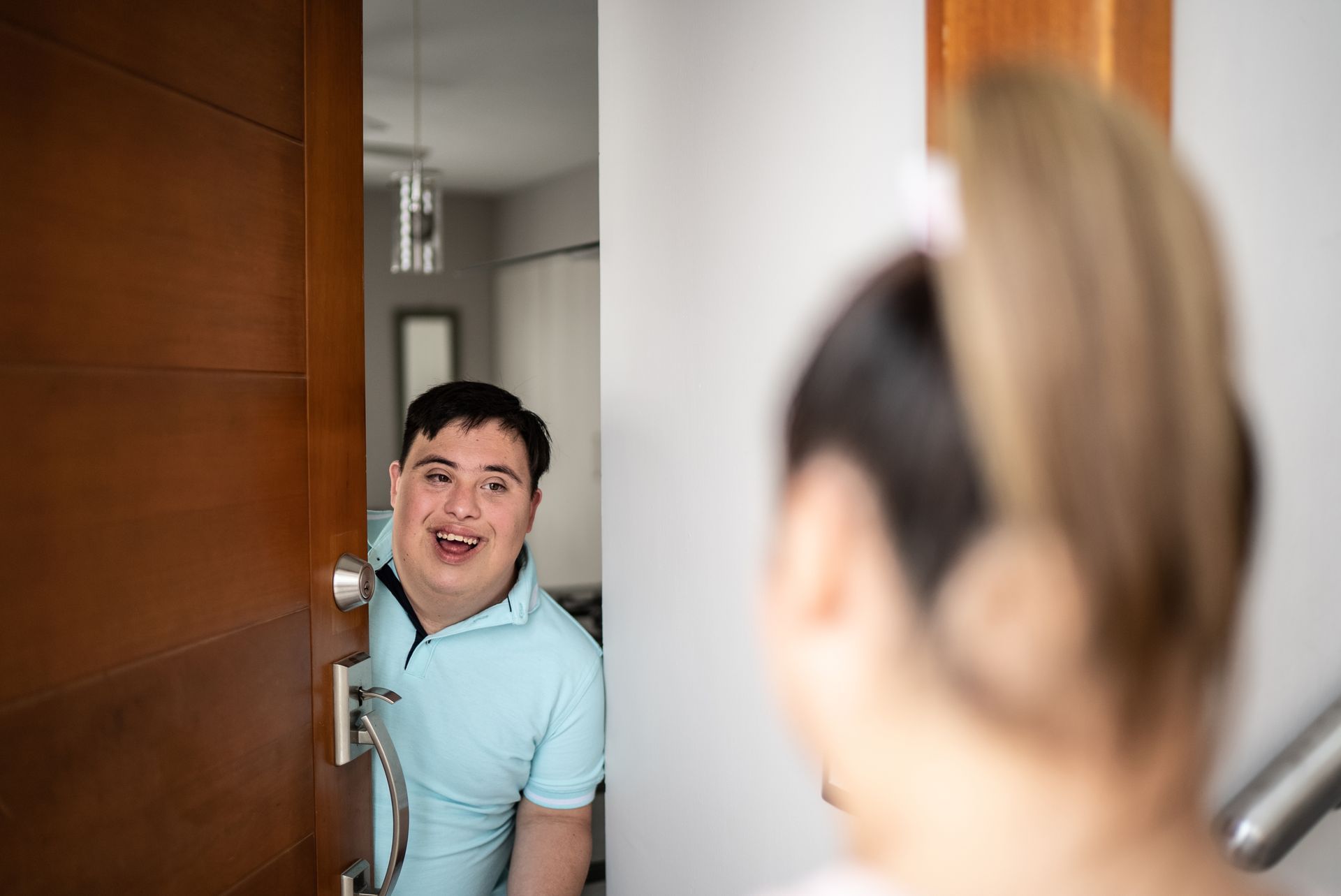 a manis smiling while standing in a doorway