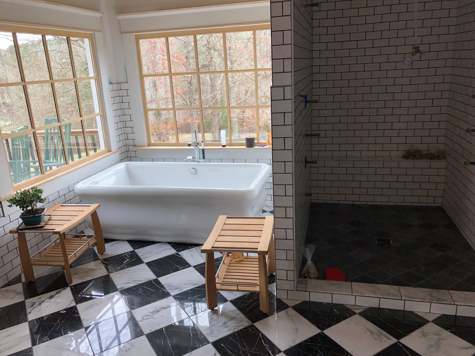 A bathroom with a bathtub and a walk in shower.