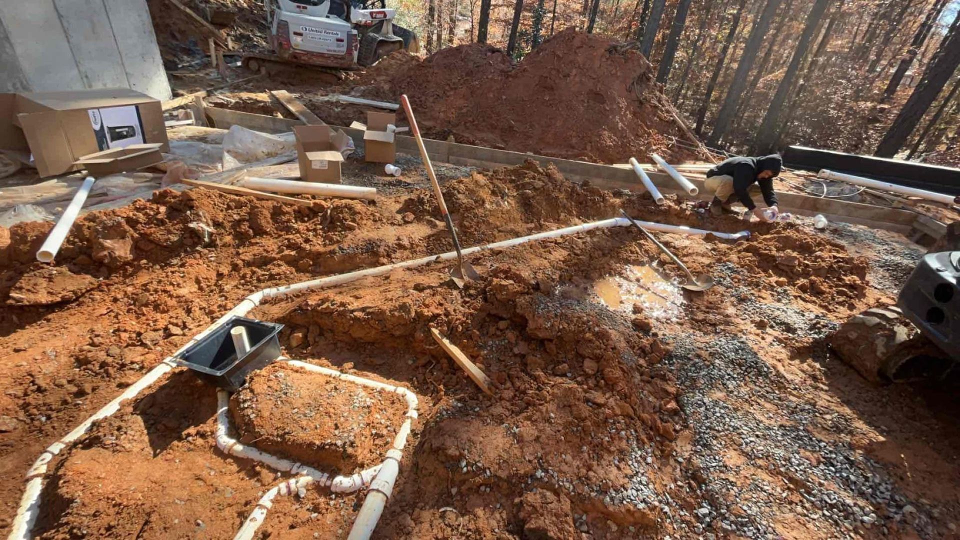 A construction site with a lot of dirt and pipes in the ground.