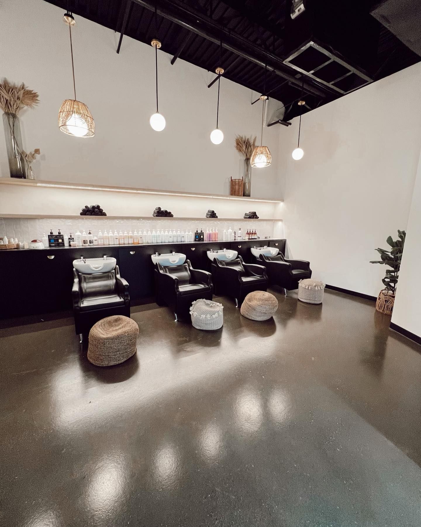 A salon with a lot of chairs and sinks