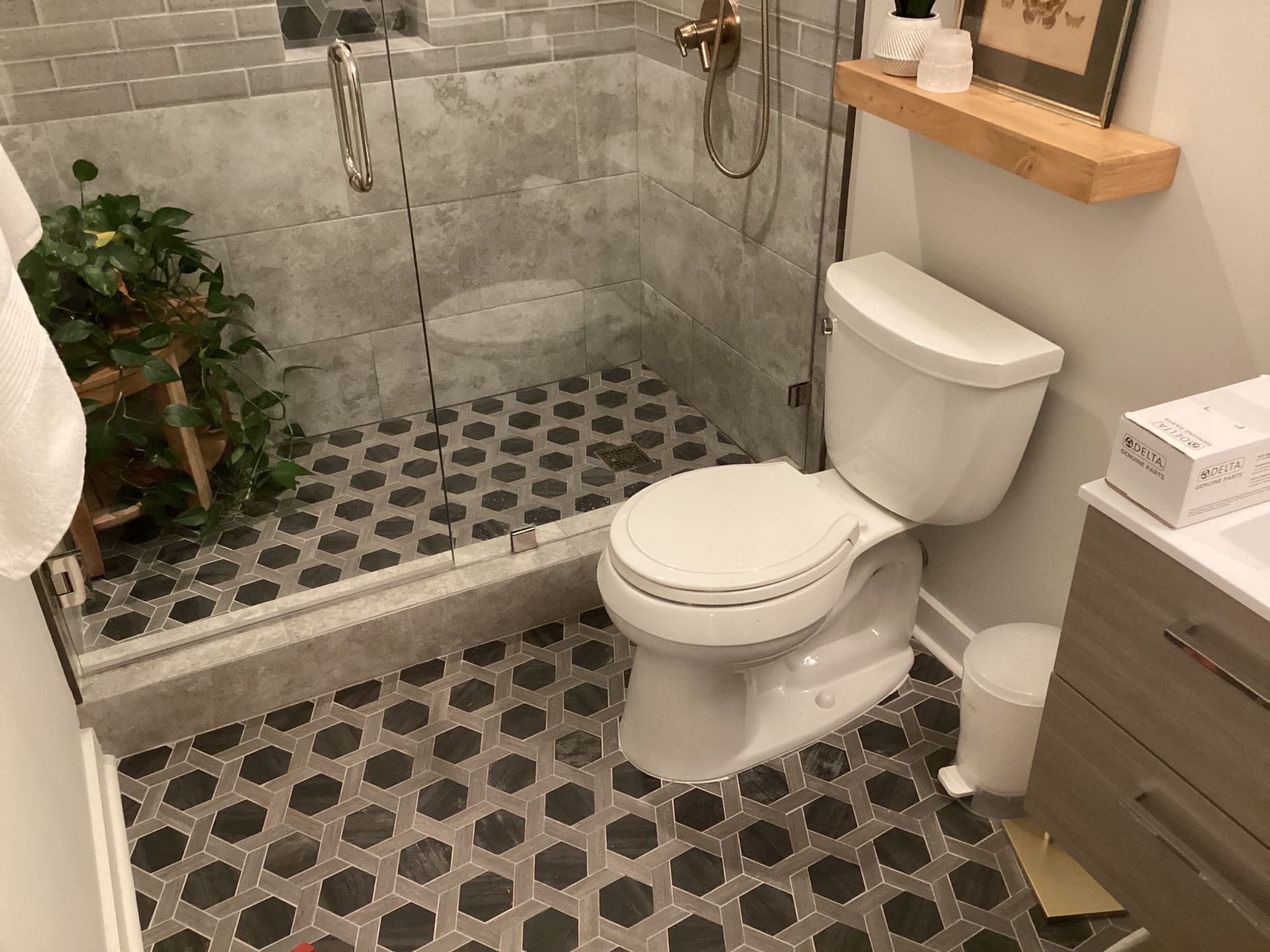A bathroom with a toilet , sink , and shower.