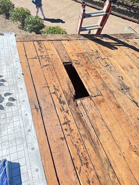 A Wooden Deck With a Hole in It and a Ladder in the Background — Novato, CA — Quevedo Roofing