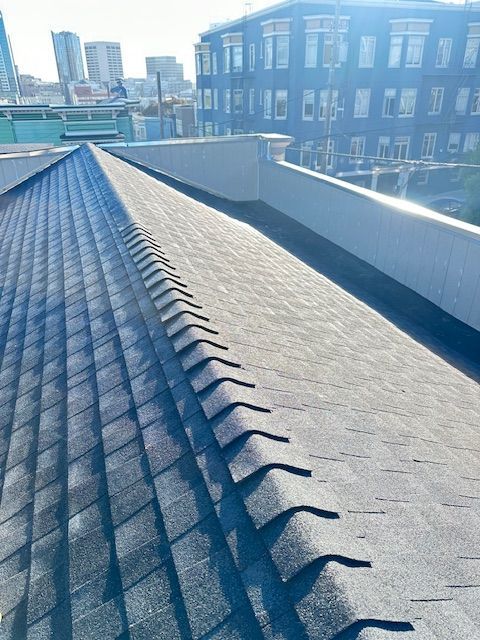 The Roof of a Building With a Lot of Shingles on It — Novato, CA — Quevedo Roofing