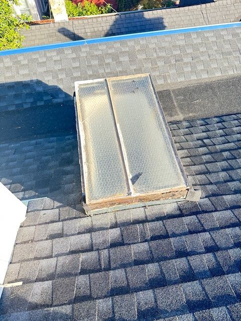 A Skylight Is Sitting on Top of a Roof — Novato, CA — Quevedo Roofing