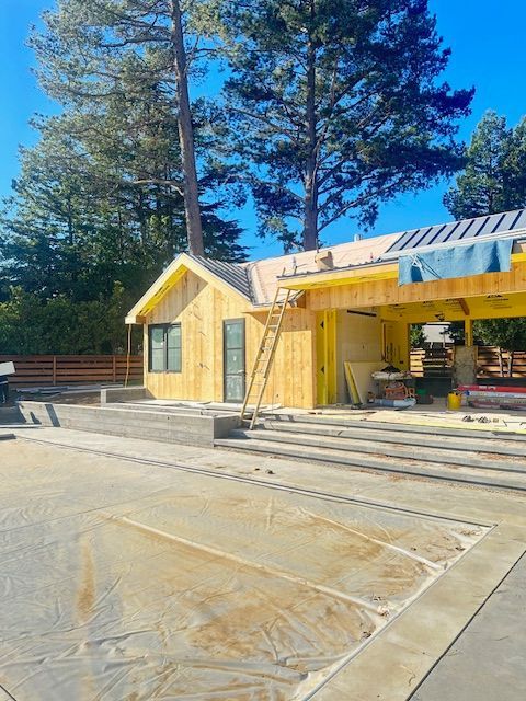 A house that is being built with a ladder in front of it.
