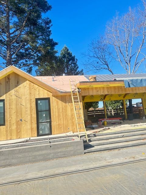 A house under construction with a ladder on the side of it