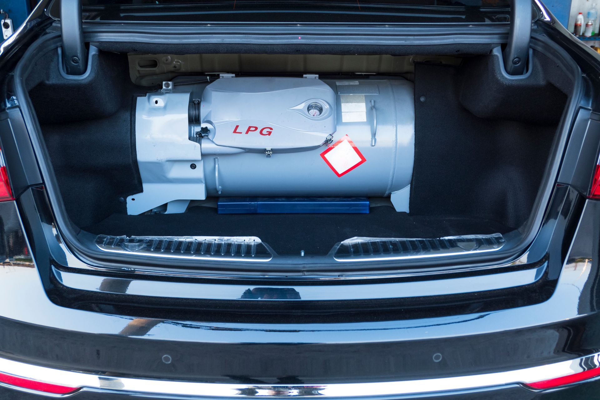 A Gray Lpg Tank Installed Inside the Trunk of a Black Car — A & D Automotive Technicians in Mackay, QLD