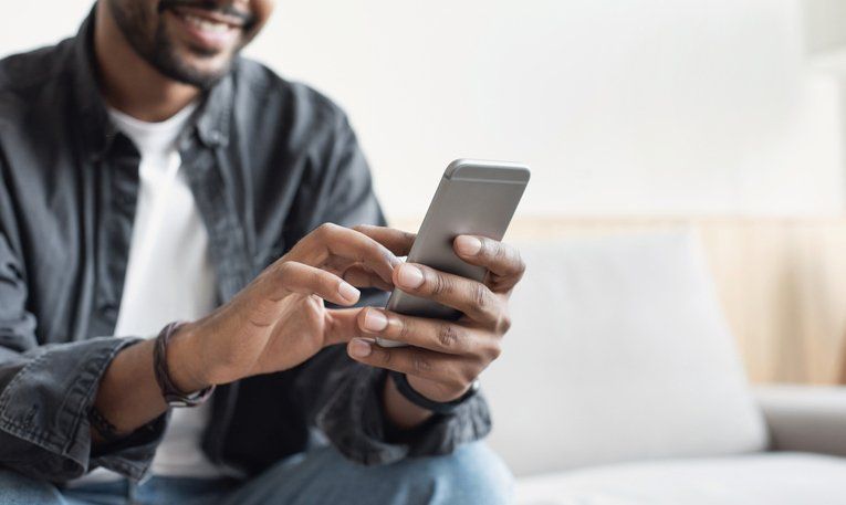 Young man using smart phone at home