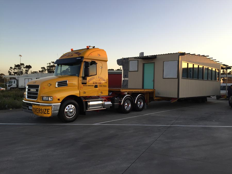 truck transporting portable home