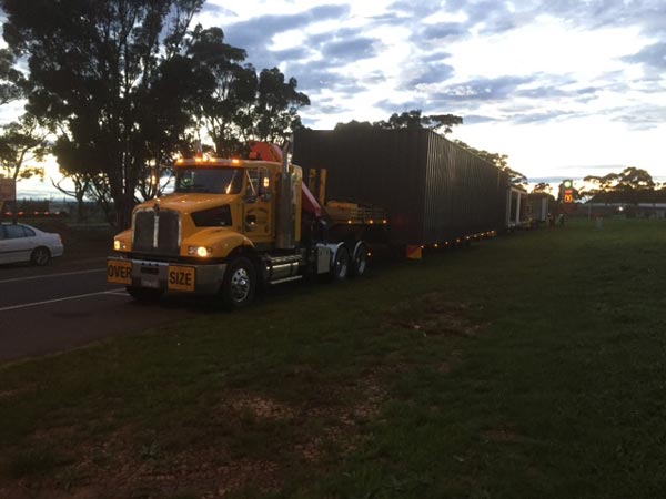 truck transporting modular home