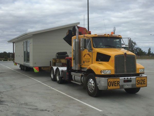 R L Harding truck transporting building