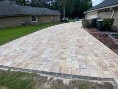 A close up of a brick pavement with a herringbone pattern.