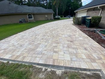 A close up of a brick pavement with a herringbone pattern.