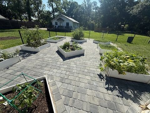 A cobblestone walkway with potted plants on the side