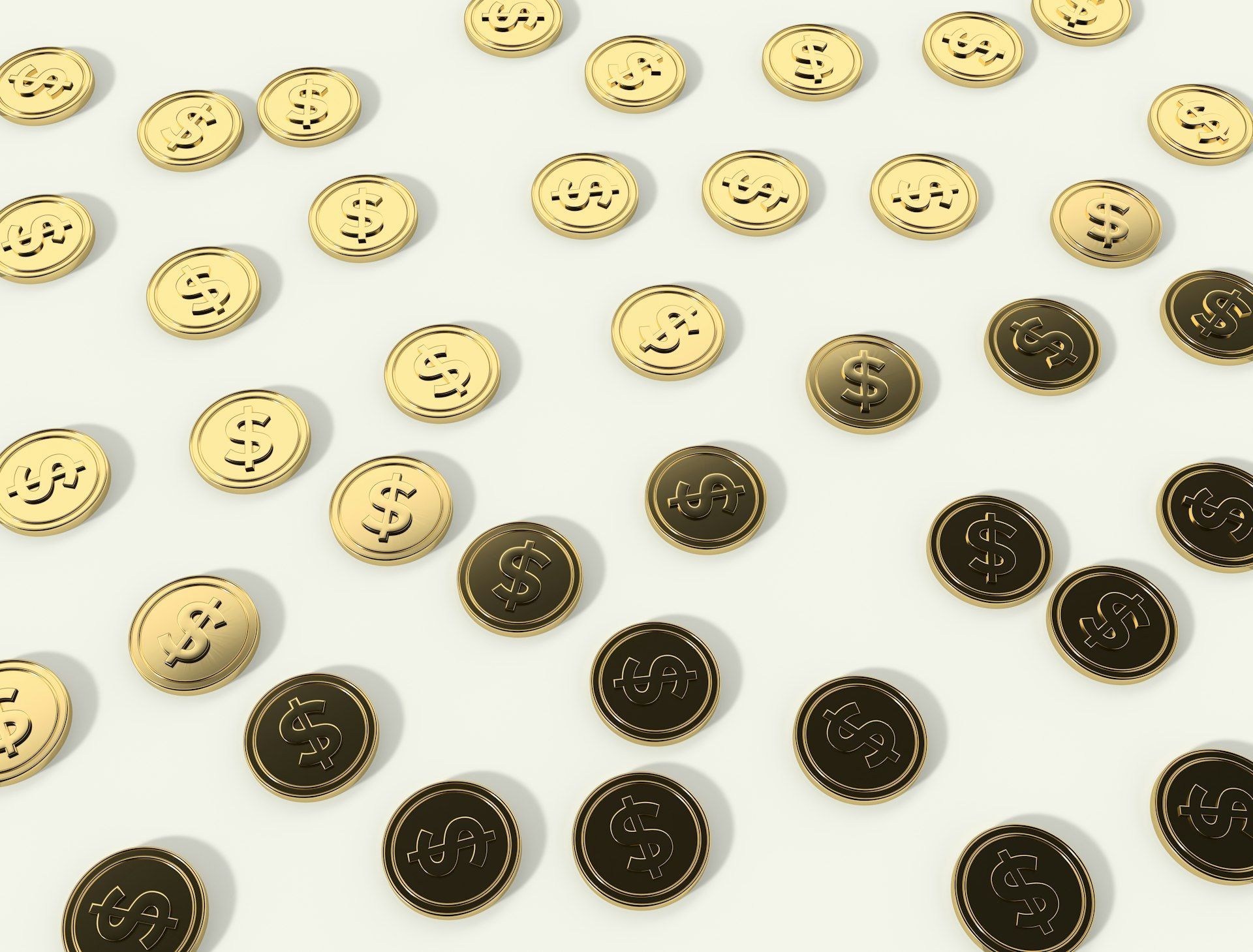 A bunch of gold and black coins on a white surface