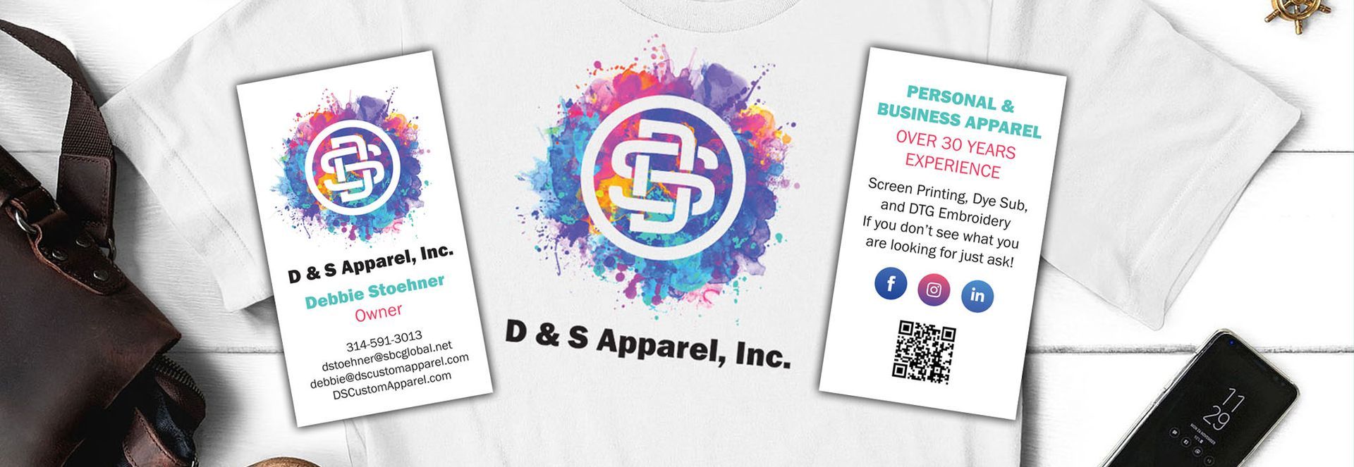 A white t-shirt with a colorful logo on it is sitting on a table.