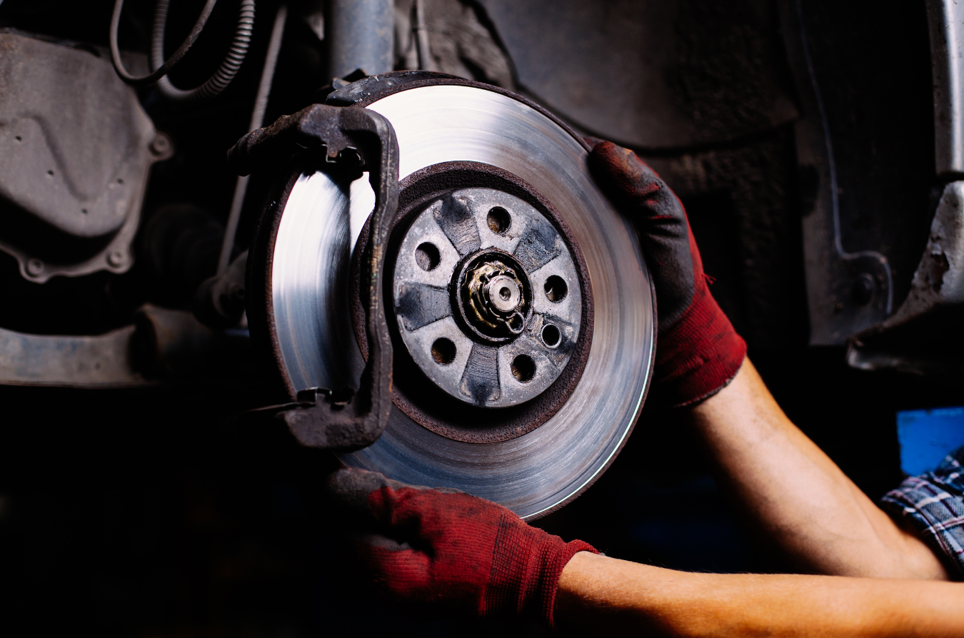 A person is fixing a brake disc on a car.
