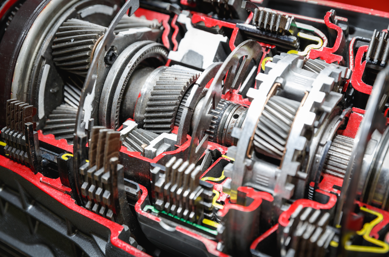 A close up of a cut in half gearbox of a car.