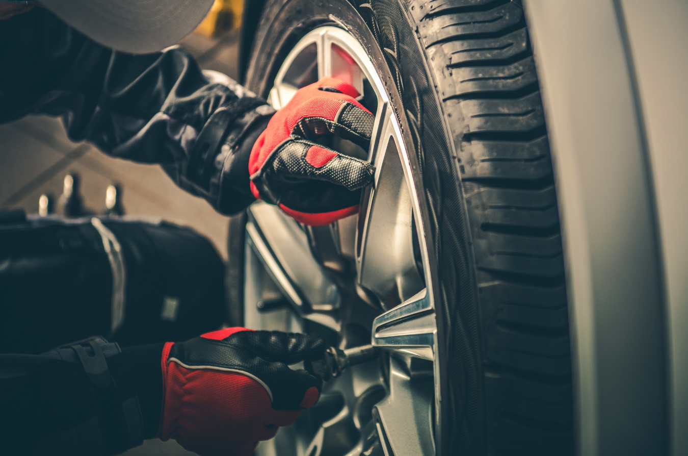 A person is changing a tire on a car.