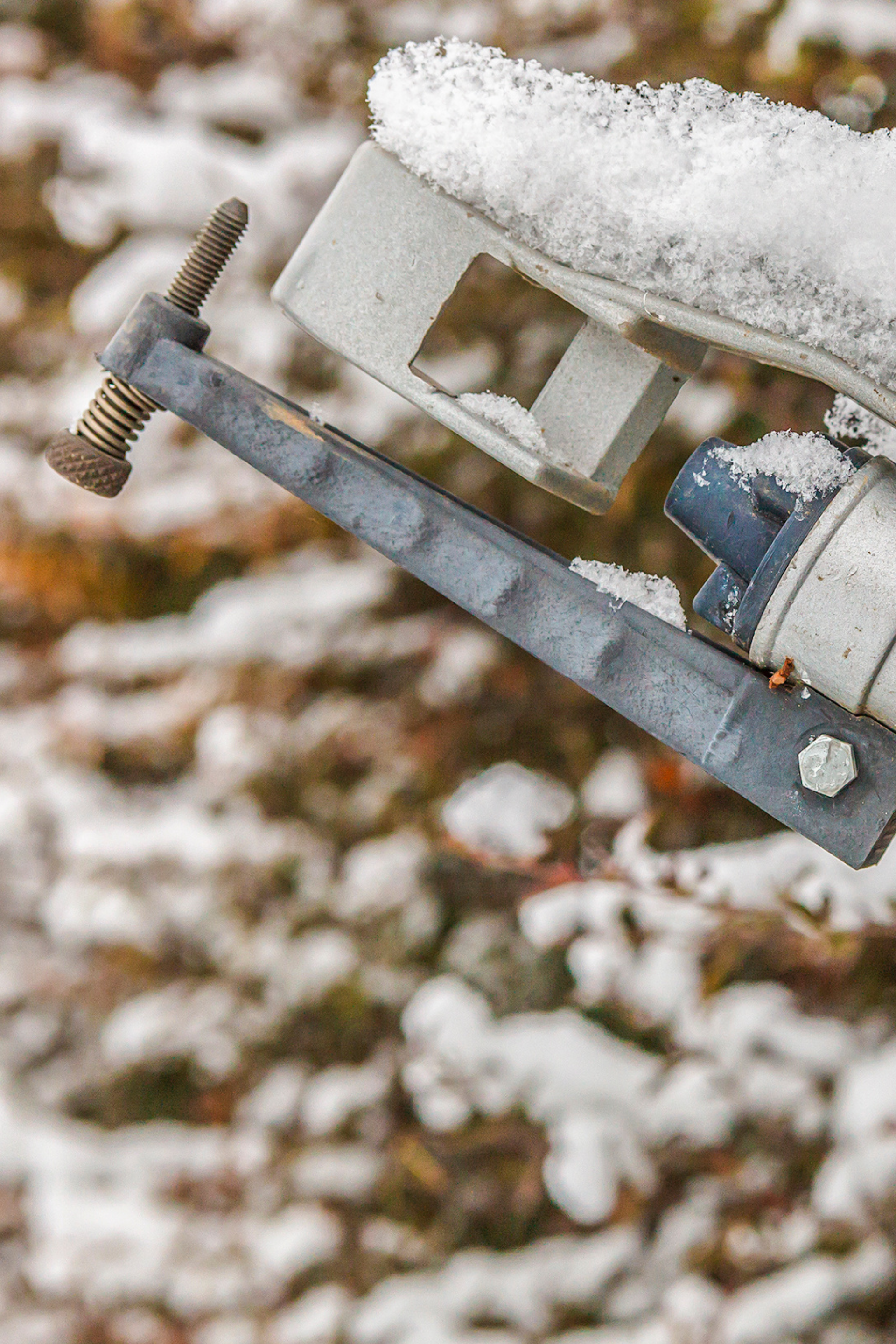 A close up of a sprinkler covered in snow.