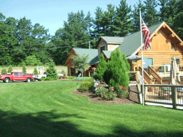 Log Cabin House with Lawn — Kent City, MI — Summit Construction, Inc.— Kent City, MI — Summit Construction, Inc.