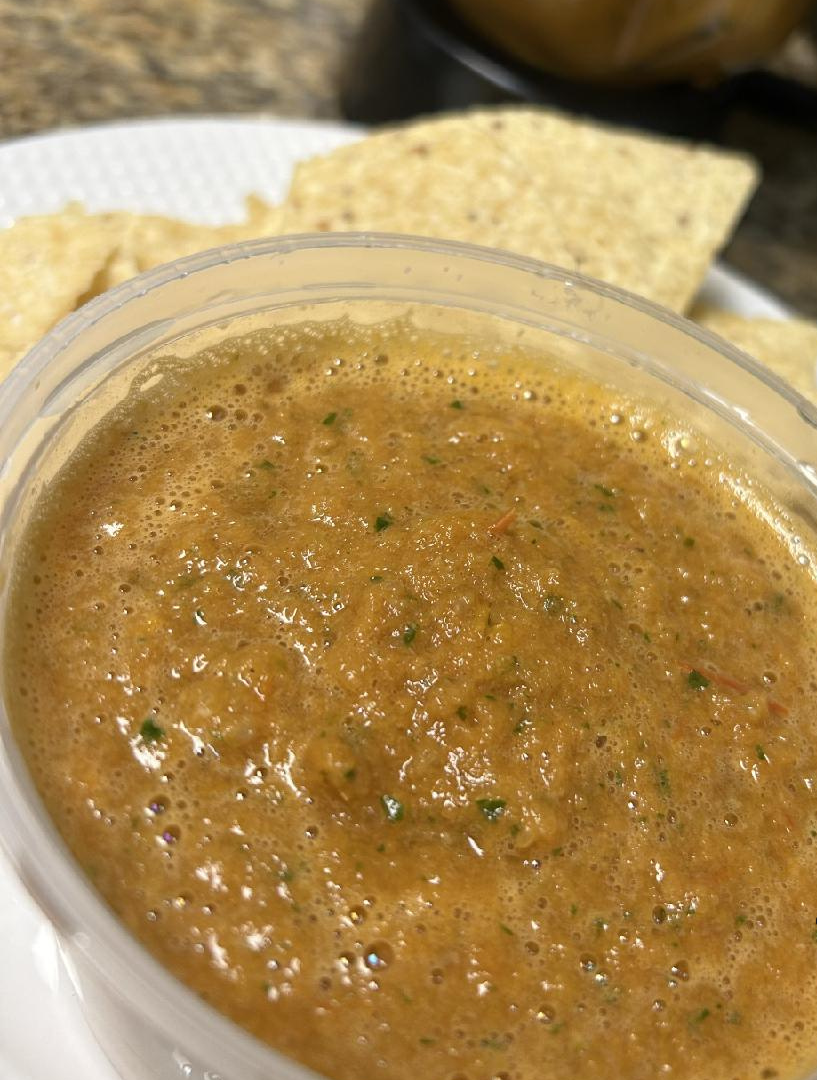 A wooden cutting board topped with tacos and a drink.
