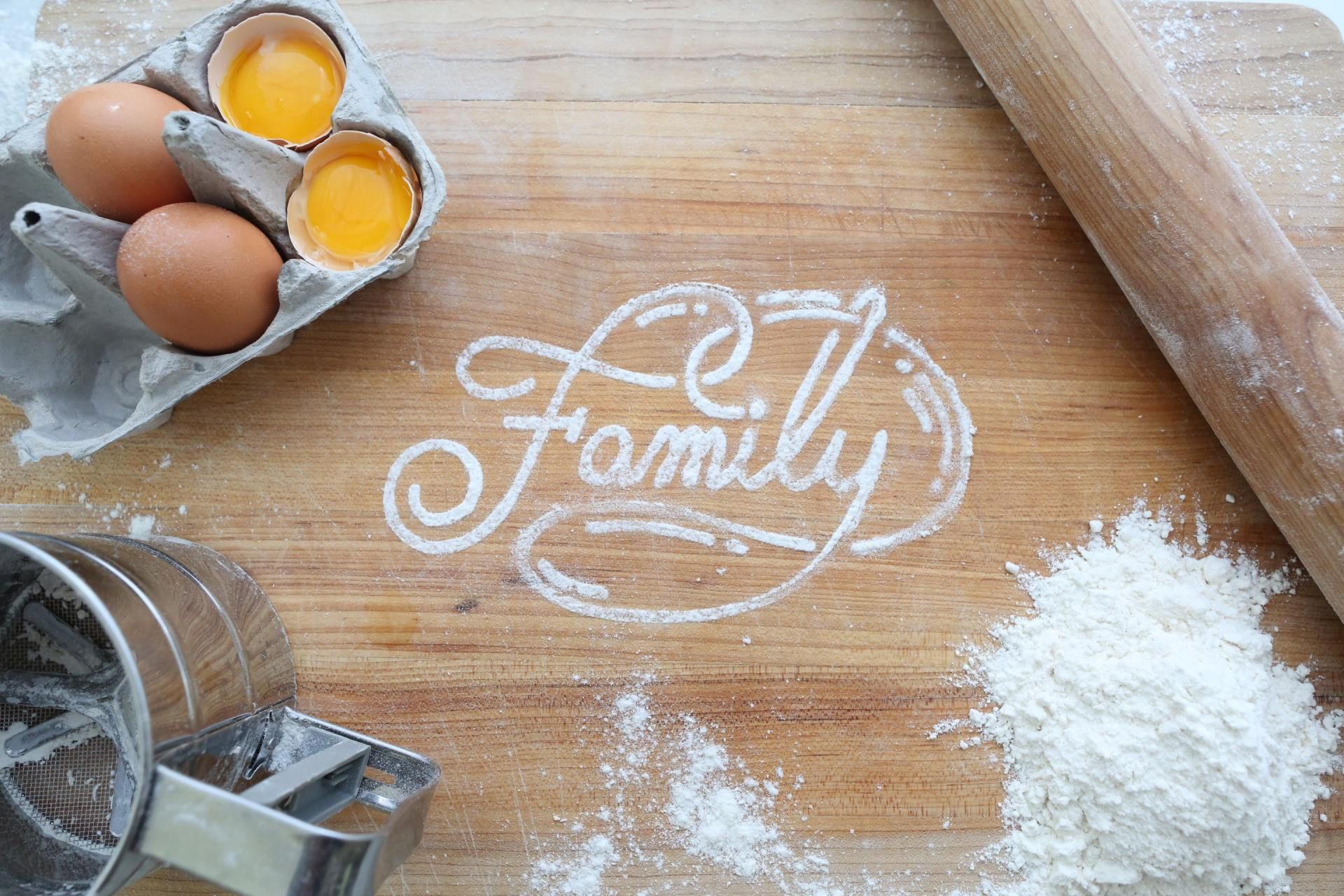 The word family spelt in flour on counter 