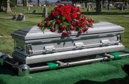 casket with roses on top 