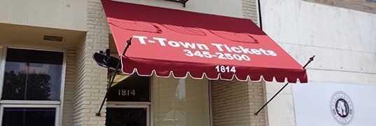 A striped awning with a blue sky in the background