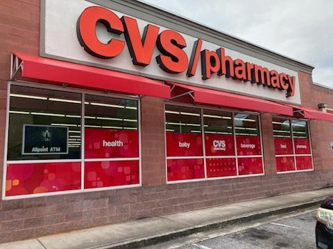A cvs / pharmacy store with a red awning