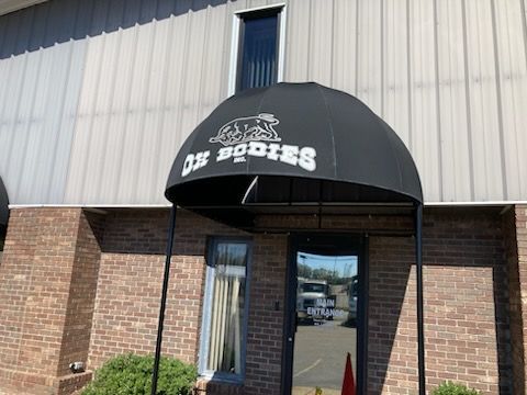 A black awning with the word bodies on it