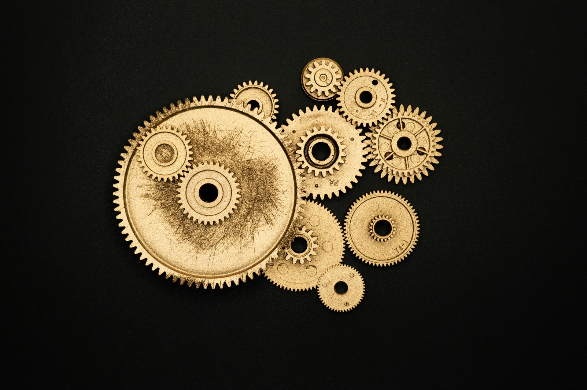 A bunch of gold gears on a black background