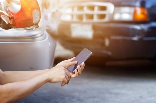 New Car Insurance Service — Hand Dialing on Phone in Gallup, NM