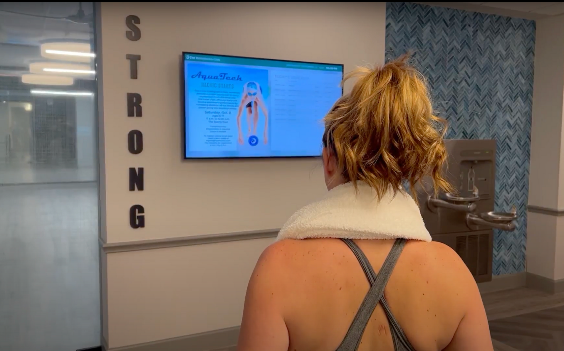 Woman looking at screen in an elevator well