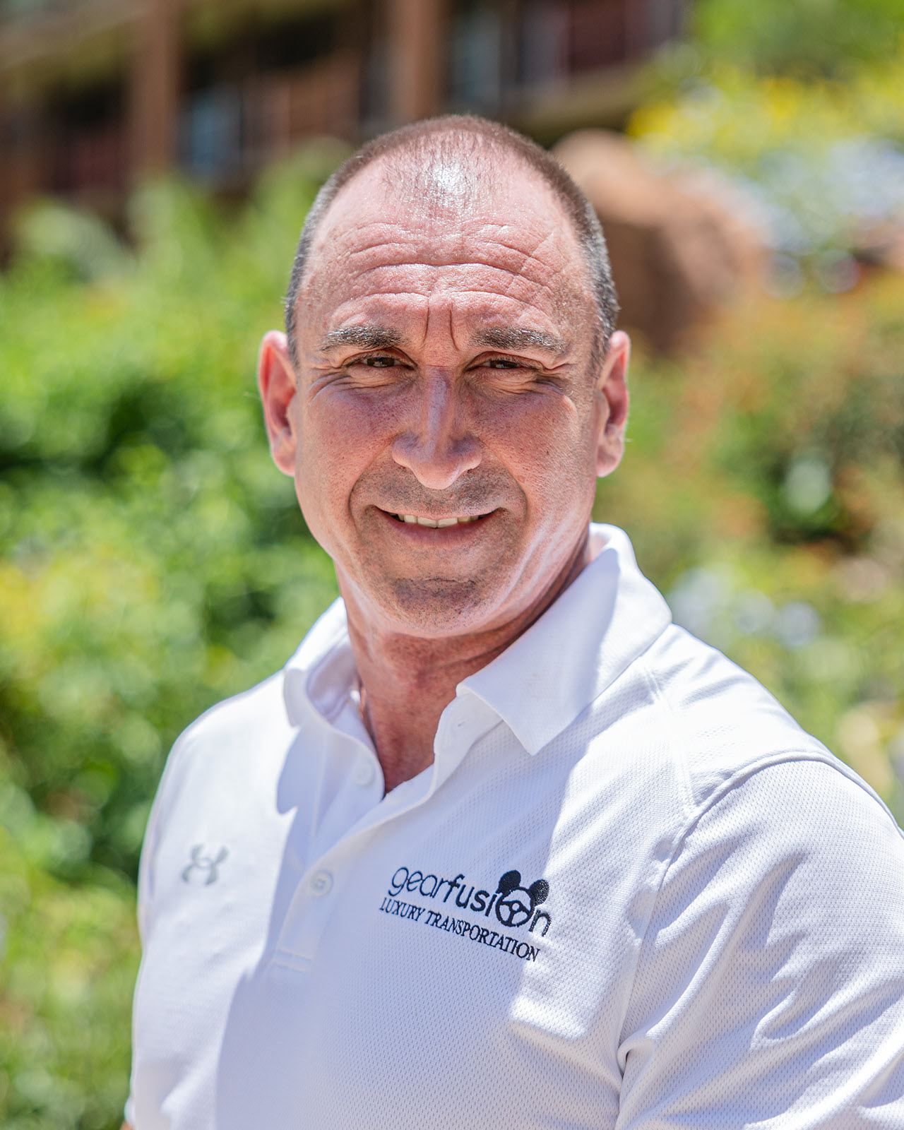 A man in a white shirt is smiling for the camera.