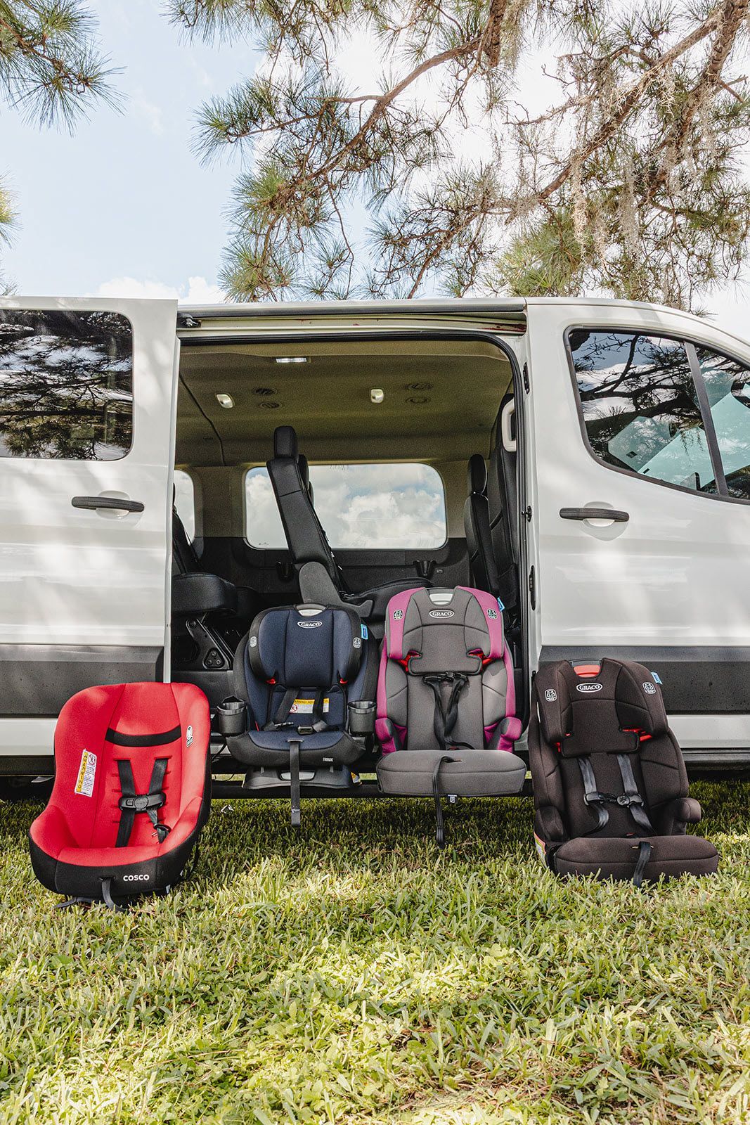 Three car seats are sitting in the back of a van.