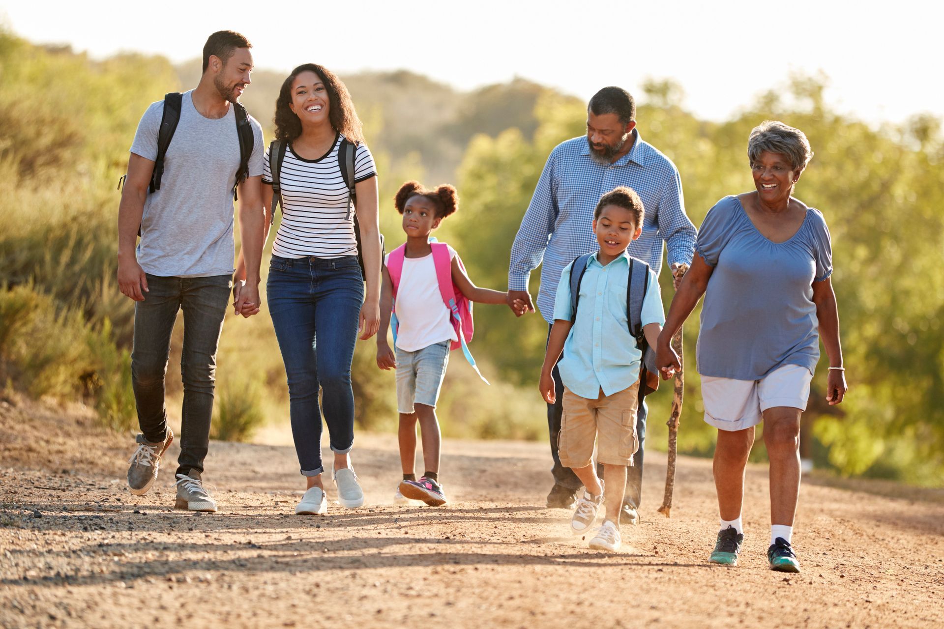 group of people walking next to a river