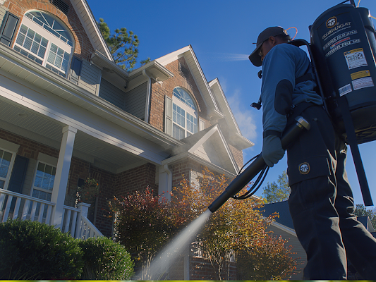 A Pest Control Technician Sprays a Residential Home's Yard — Pest Storm In Lake Macquarie, NSW