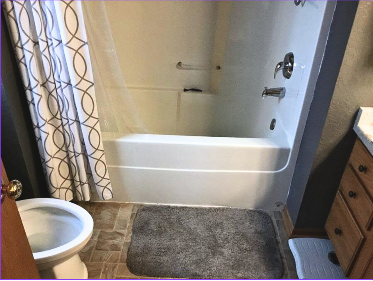 A bathroom with a bathtub, toilet and sink