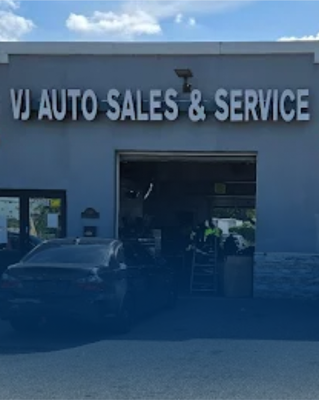 VJ Auto Sales & Service storefront with a dark car parked in front. | VJ Auto Sales & Service