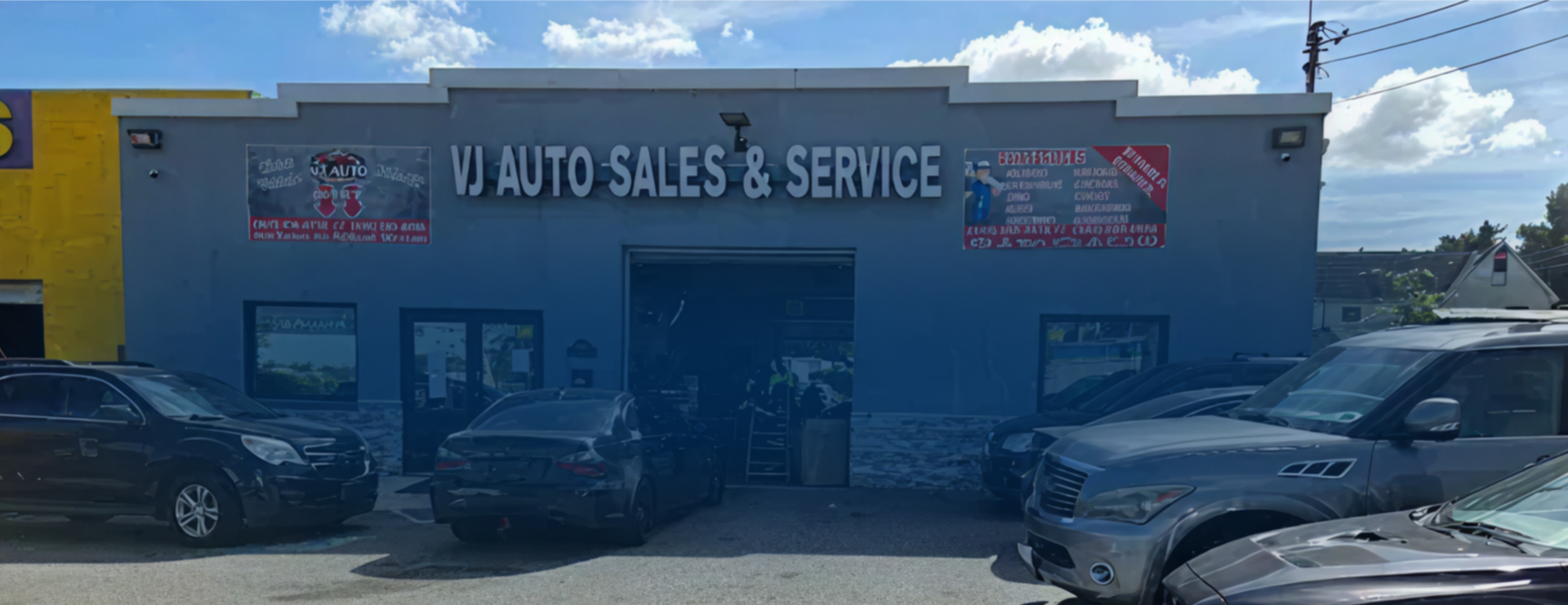 VJ Auto Sales & Service building with cars parked out front on a sunny day. | VJ Auto Sales & Service