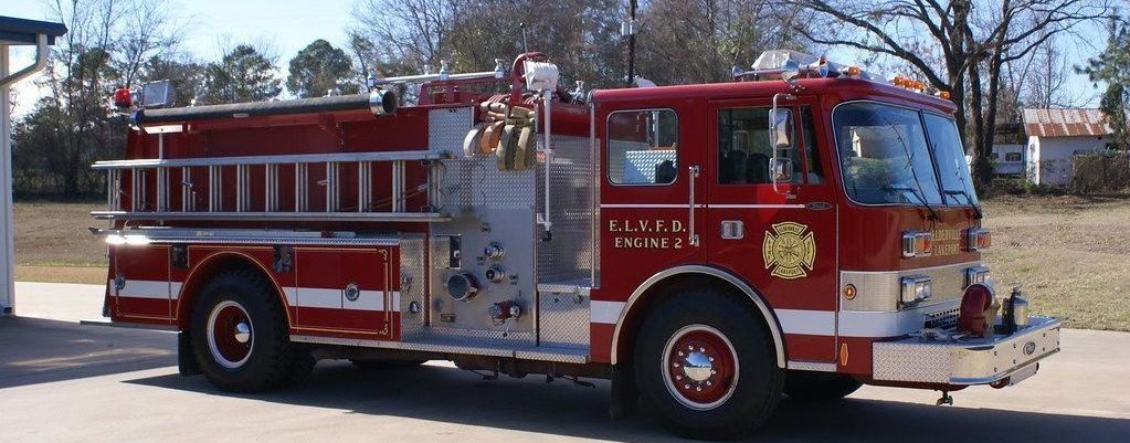 A red fire truck is parked on the side of the road