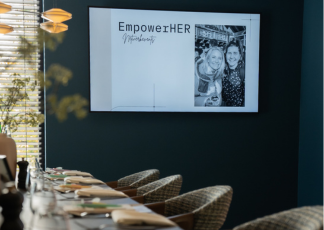 A table topped with plates of food and wine glasses.