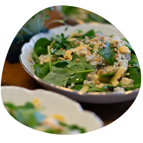 A pizza with broccoli zucchini and onions on it