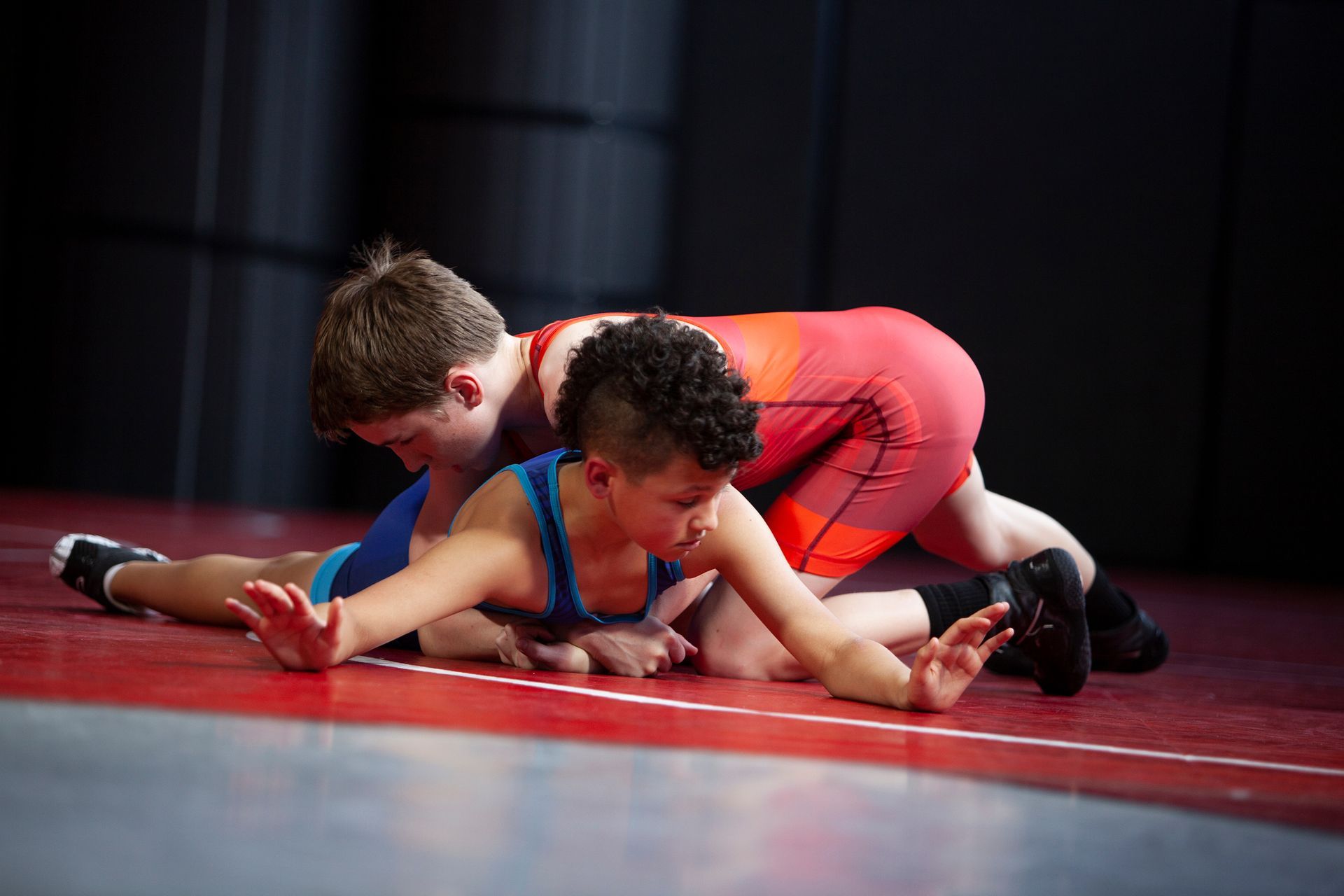 Basketball about to go through a hoop.