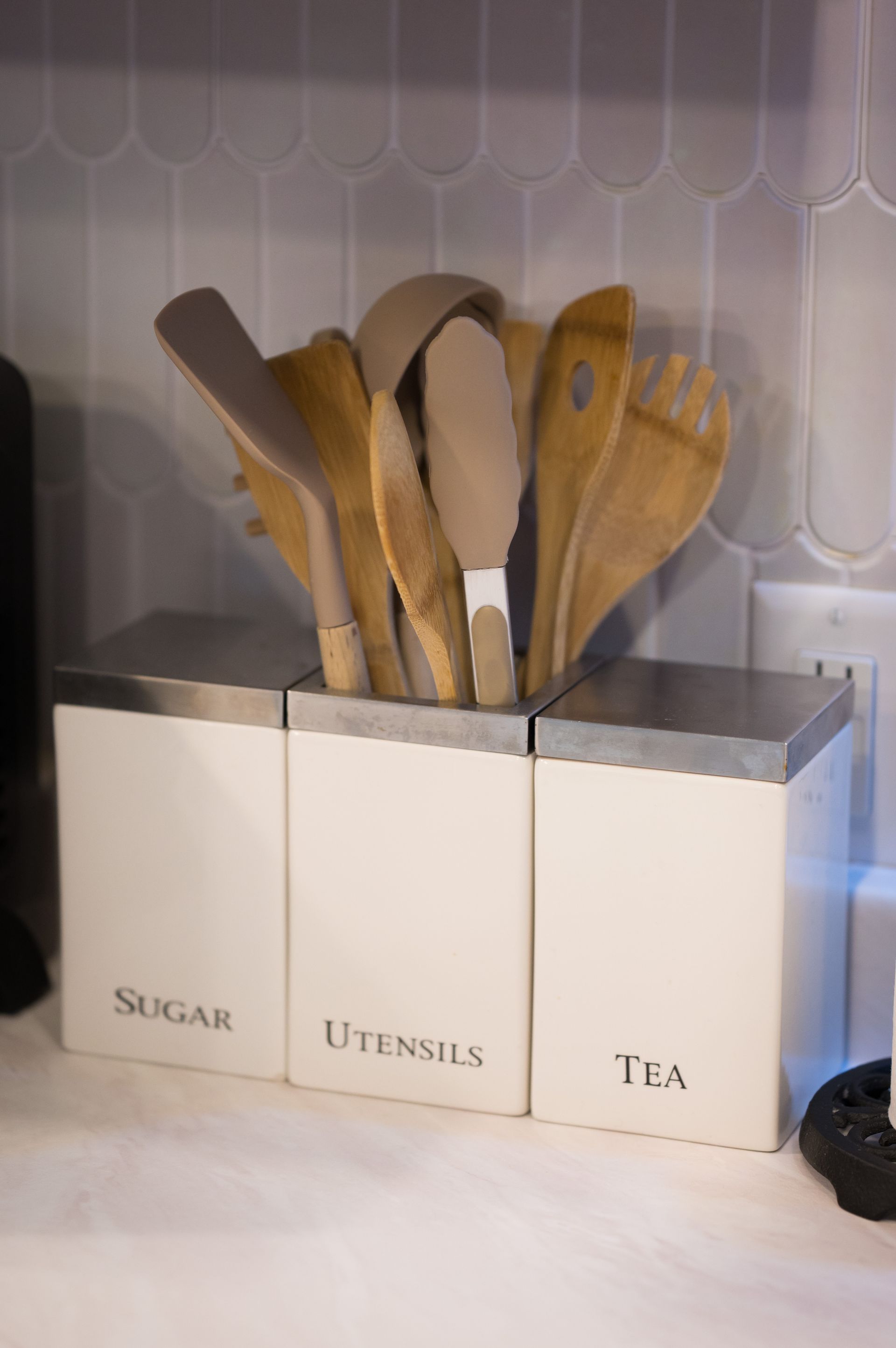 Three white canisters labeled 