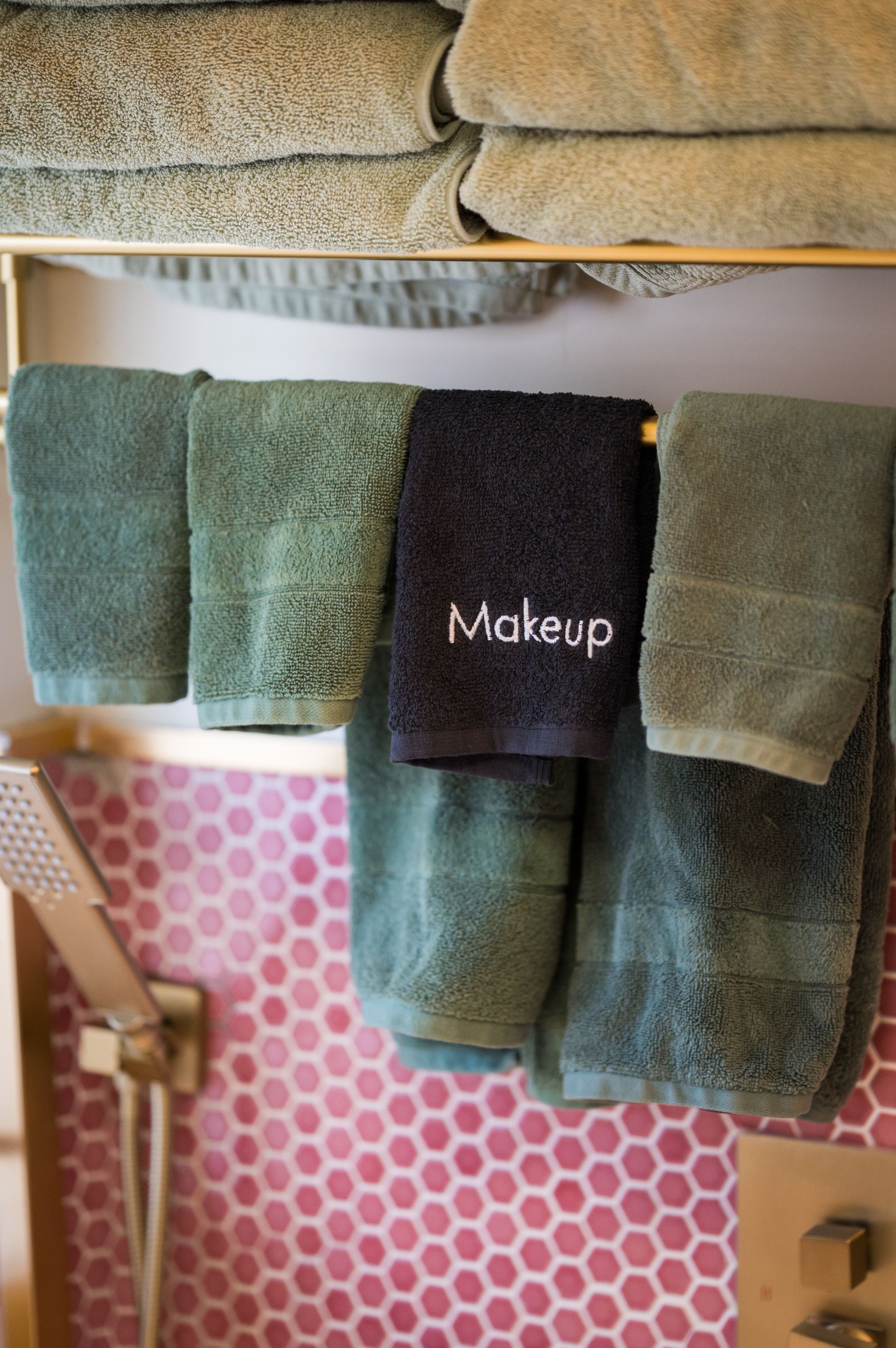 Towels in shades of green, with one labeled 